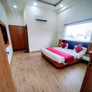 Deluxe room interior at Vrindavan Hotel with double bed, AC and modern amenties